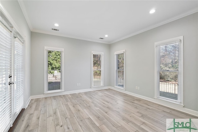 unfurnished room featuring light wood finished floors, visible vents, and crown molding