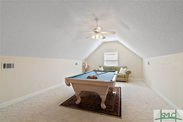 recreation room featuring carpet, lofted ceiling, visible vents, a textured ceiling, and baseboards