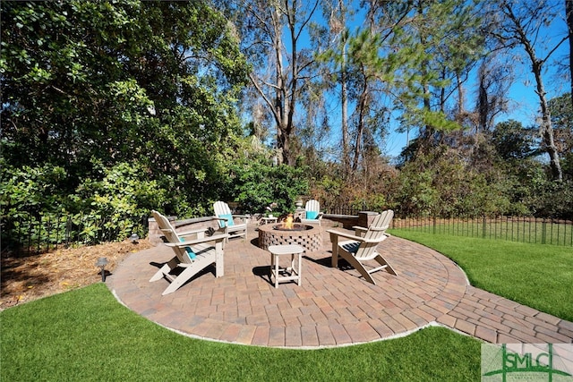 view of patio with an outdoor fire pit and fence