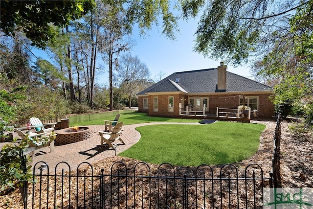 view of yard with fence private yard, a patio area, and an outdoor fire pit