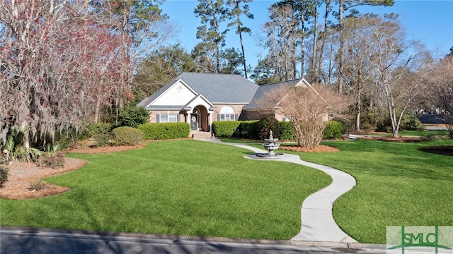 view of front of property featuring brick siding and a front yard