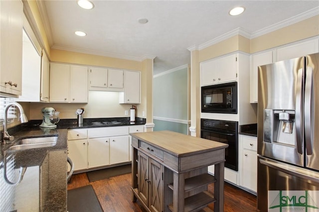 kitchen featuring a sink, black appliances, dark wood finished floors, and ornamental molding