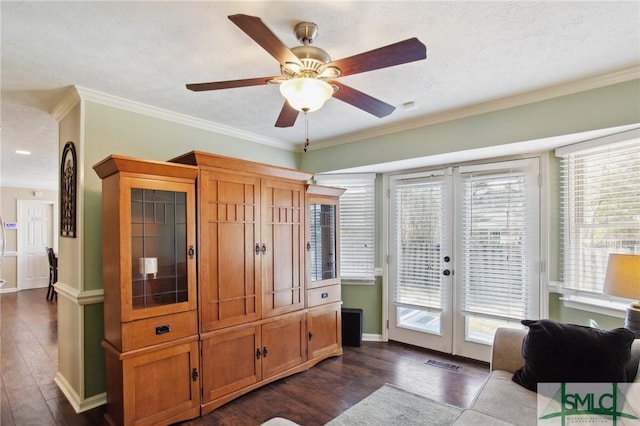 interior space featuring dark wood-type flooring, visible vents, and ornamental molding