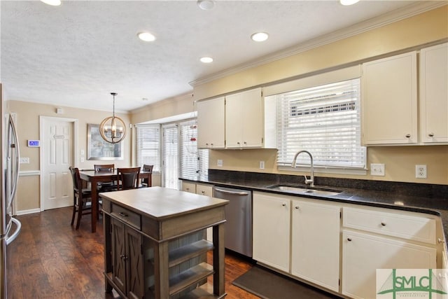 kitchen with dishwasher, dark countertops, dark wood-style floors, and a sink