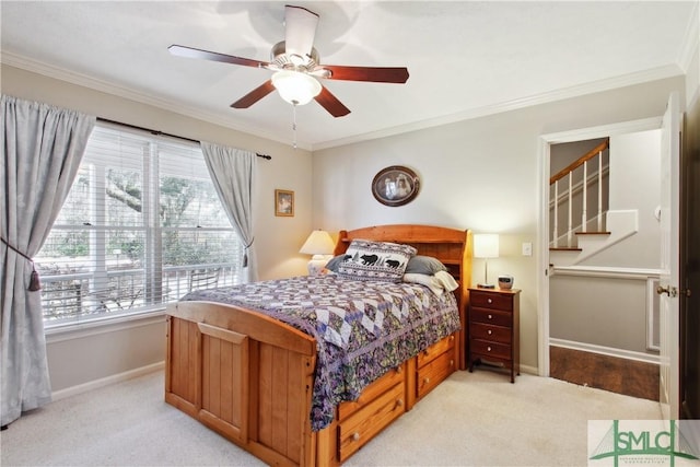 bedroom with light carpet, a ceiling fan, baseboards, and ornamental molding