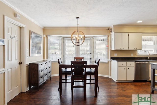 dining area with dark wood finished floors, a notable chandelier, a textured ceiling, and crown molding