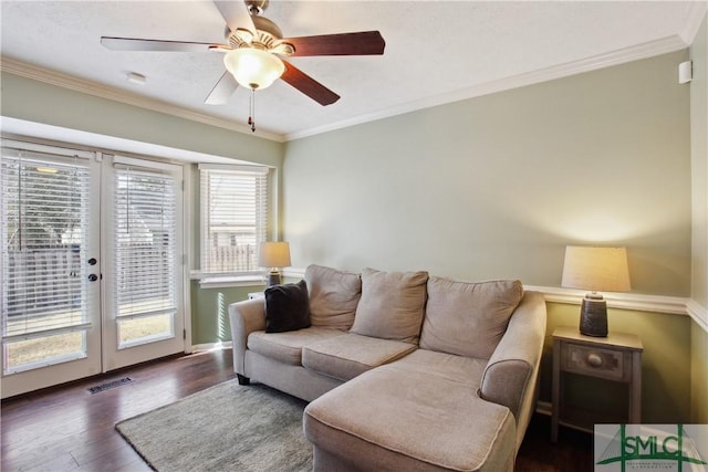 living room with visible vents, crown molding, french doors, wood finished floors, and a ceiling fan