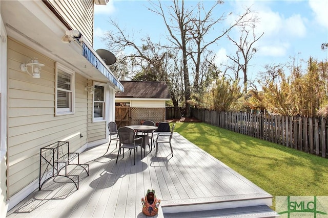 deck featuring a yard, outdoor dining area, and a fenced backyard