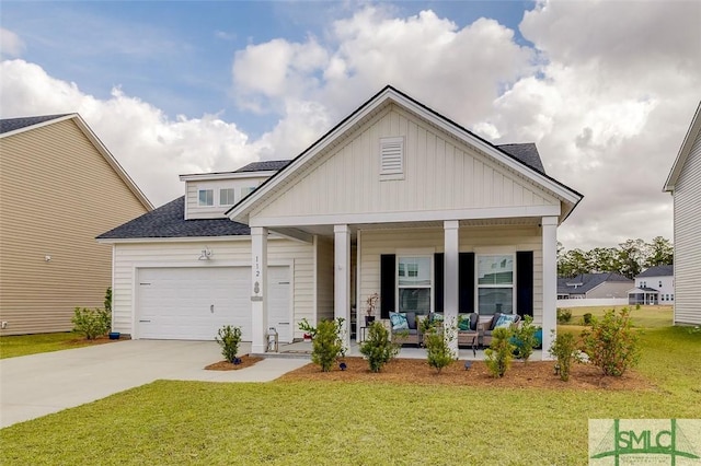 view of front of home with a garage, a shingled roof, concrete driveway, covered porch, and a front lawn