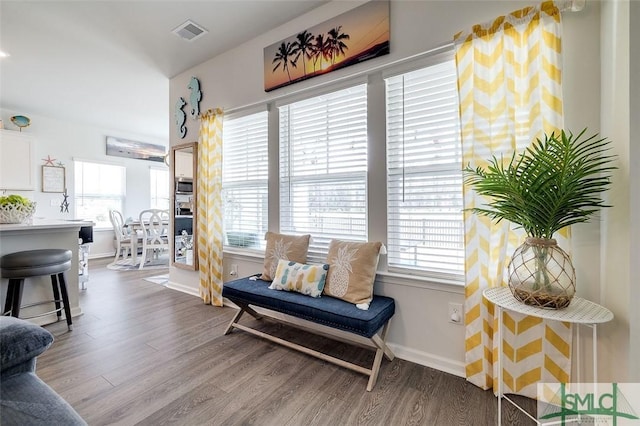 sitting room featuring wood finished floors, visible vents, and baseboards