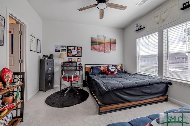 bedroom featuring carpet floors, baseboards, visible vents, and a ceiling fan