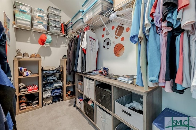 walk in closet featuring carpet flooring