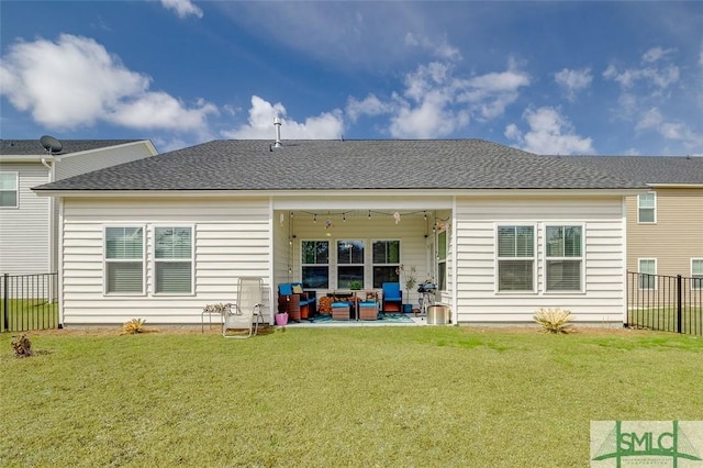 back of property featuring a patio, a lawn, fence, and roof with shingles