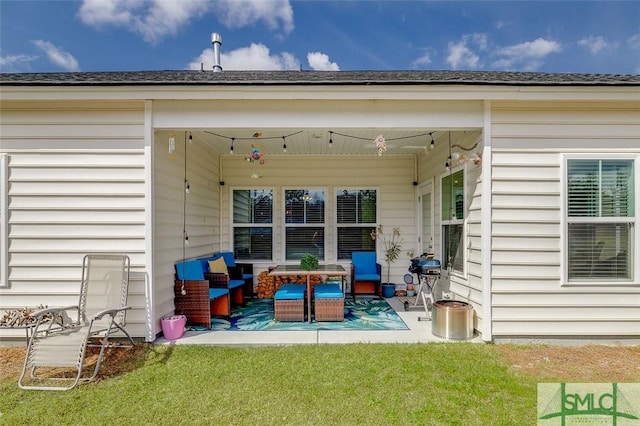 back of house with a shingled roof, a patio area, a lawn, and an outdoor hangout area