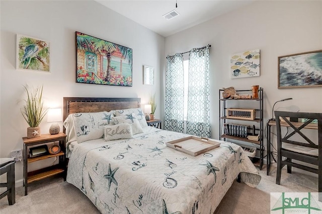 carpeted bedroom featuring visible vents