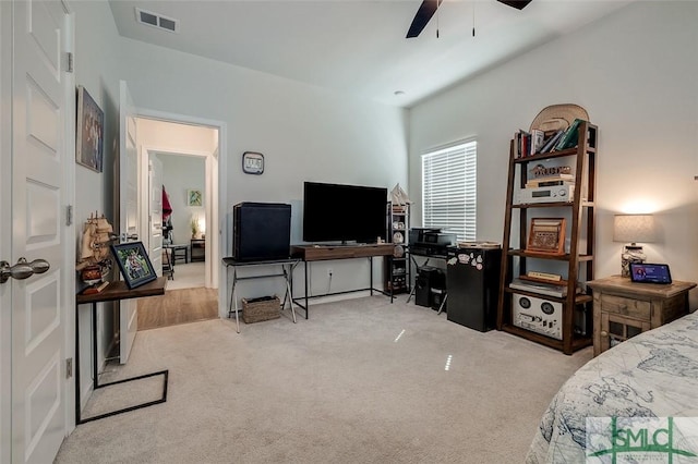 carpeted bedroom with ceiling fan and visible vents