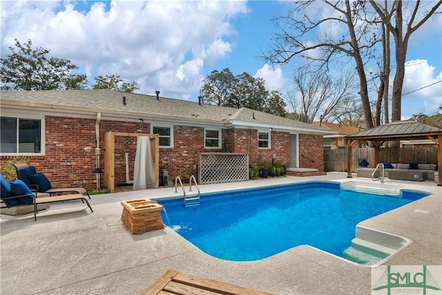 view of pool with an outdoor living space, a patio area, a gazebo, fence, and a fenced in pool