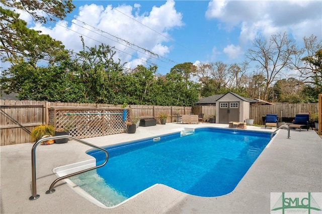 view of pool featuring an outbuilding, a patio area, a fenced in pool, a fenced backyard, and a storage unit