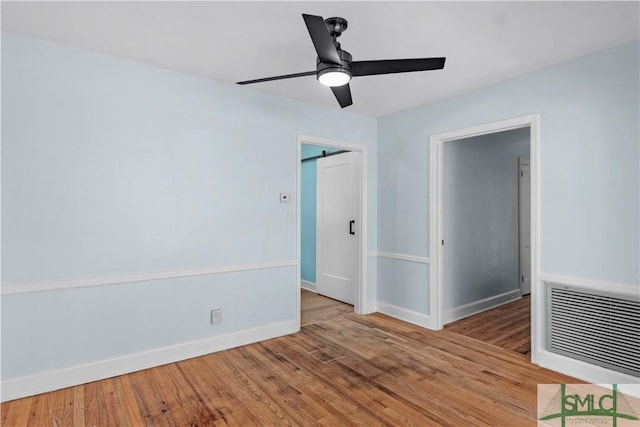 interior space featuring visible vents, light wood finished floors, and baseboards