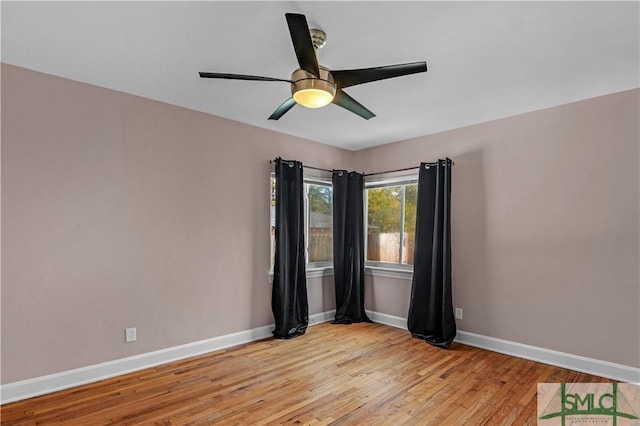 unfurnished room featuring baseboards, a ceiling fan, and light wood-style flooring