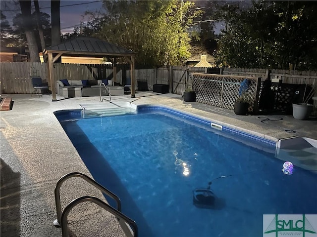 view of swimming pool with a patio, a fenced backyard, an outdoor hangout area, a fenced in pool, and a gazebo