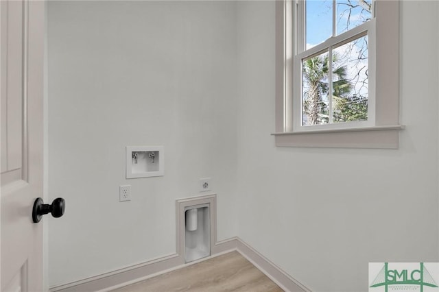 washroom with hookup for an electric dryer, laundry area, washer hookup, baseboards, and light wood-type flooring