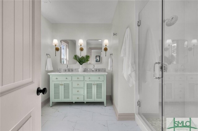 bathroom with marble finish floor, double vanity, a stall shower, and baseboards