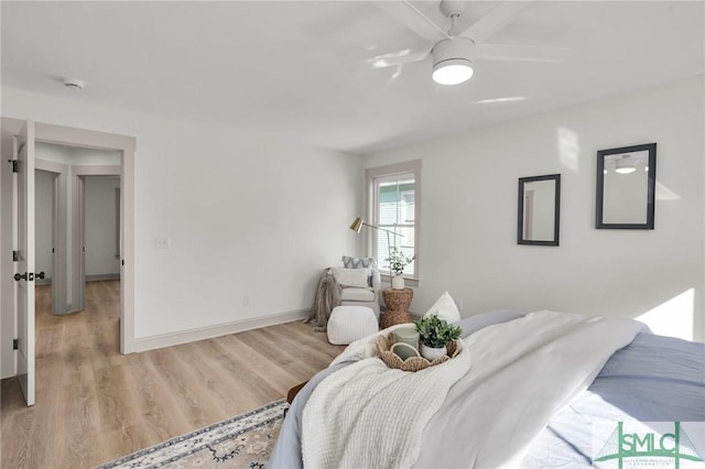 bedroom with light wood-style flooring and baseboards