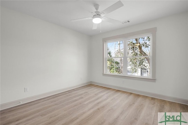 unfurnished room with light wood-type flooring, baseboards, visible vents, and a ceiling fan