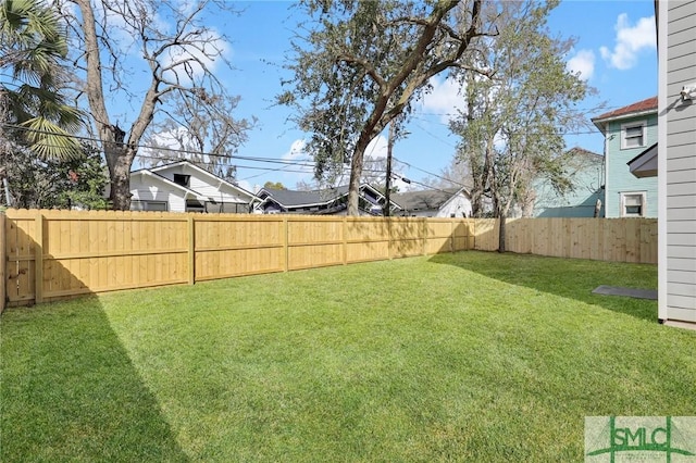 view of yard with a fenced backyard