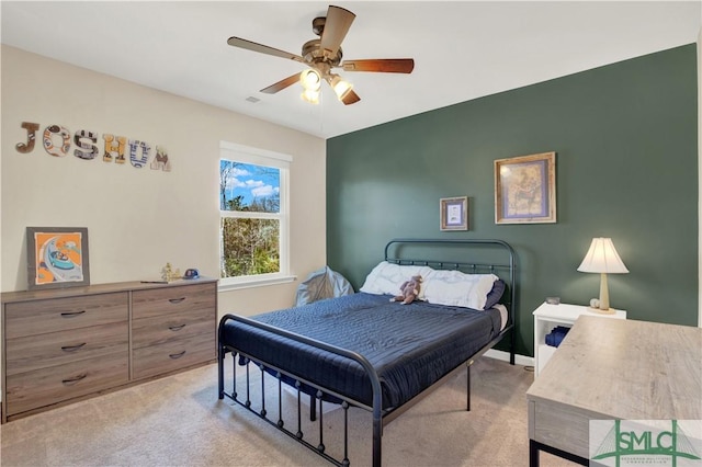 bedroom with baseboards, a ceiling fan, and light colored carpet