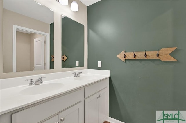 bathroom featuring double vanity, a sink, and baseboards