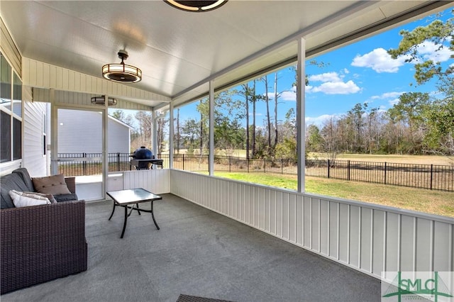 sunroom featuring lofted ceiling