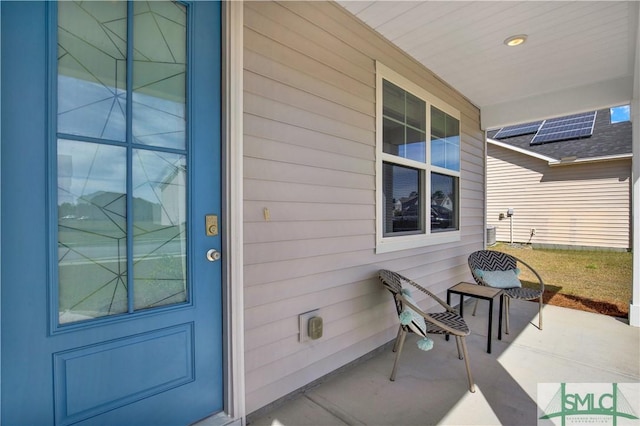 view of exterior entry featuring covered porch