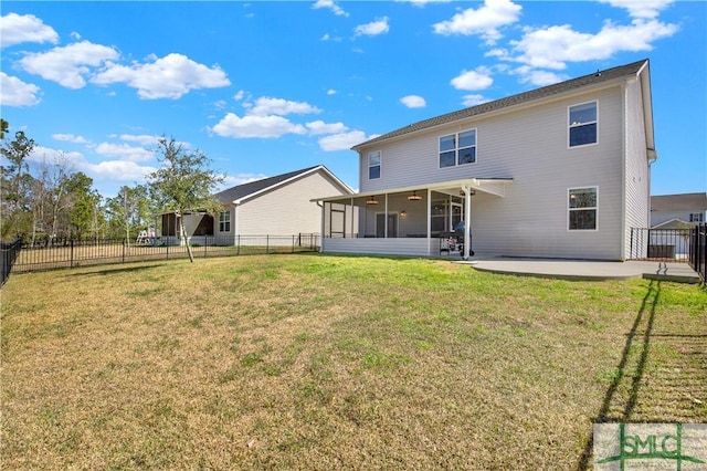 rear view of property featuring a lawn, a patio area, a fenced backyard, and a sunroom