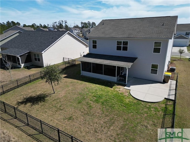 rear view of house featuring a lawn, a patio area, fence private yard, and a sunroom