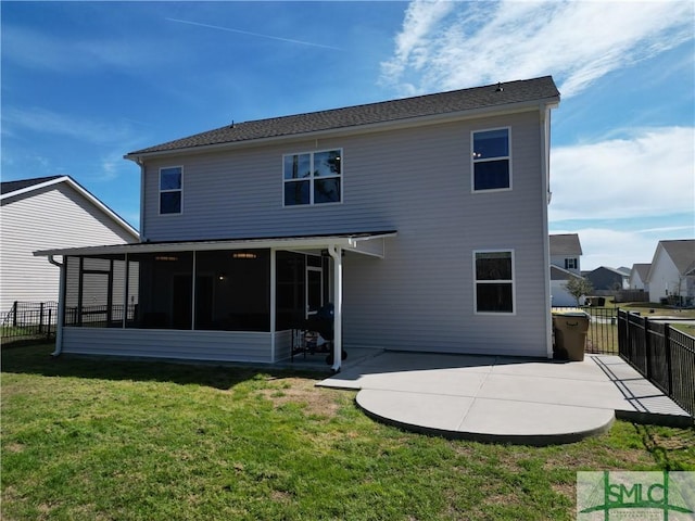 rear view of house with a yard, a patio, fence, and a sunroom