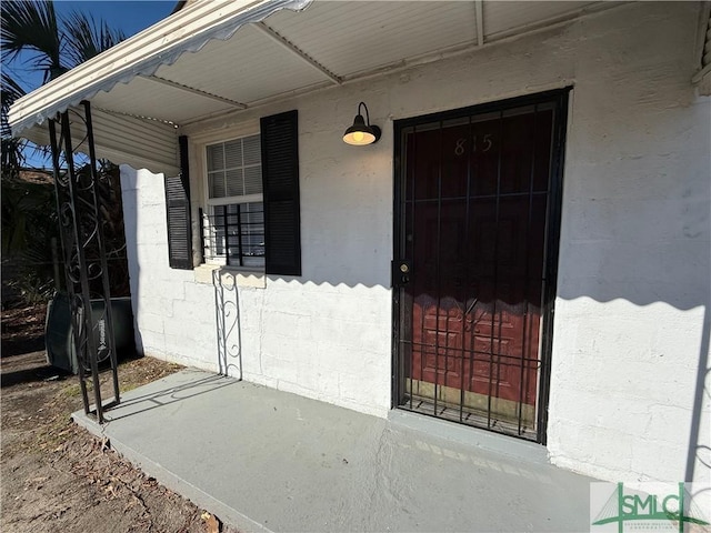 property entrance with concrete block siding