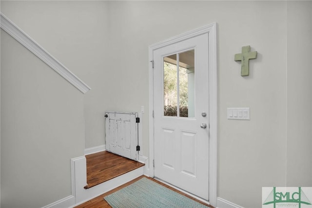 entryway featuring baseboards and wood finished floors