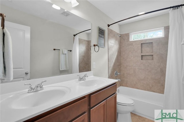 bathroom featuring toilet, shower / tub combo, a sink, and visible vents