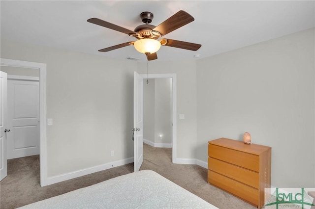 carpeted bedroom featuring visible vents, baseboards, and a ceiling fan