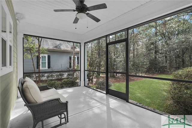 sunroom featuring a ceiling fan and plenty of natural light