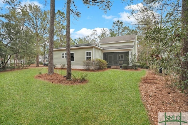 view of front of property with a front yard and a sunroom