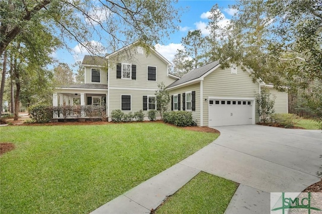 view of front of home with a garage, a front yard, and concrete driveway