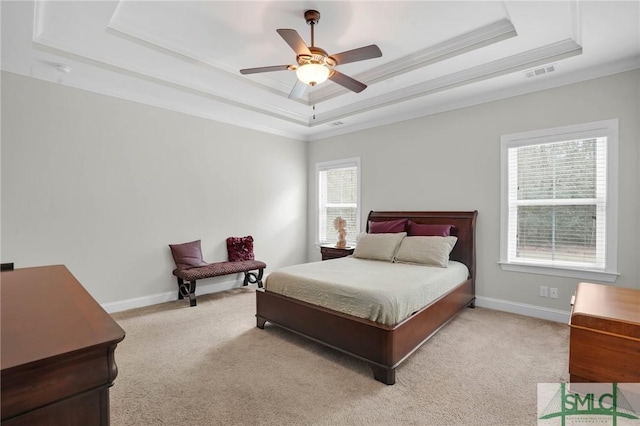 bedroom with baseboards, a raised ceiling, visible vents, and light colored carpet