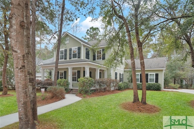 view of front of house featuring covered porch and a front lawn