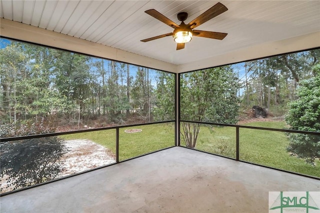 unfurnished sunroom with ceiling fan