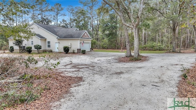 view of home's exterior featuring an attached garage and driveway