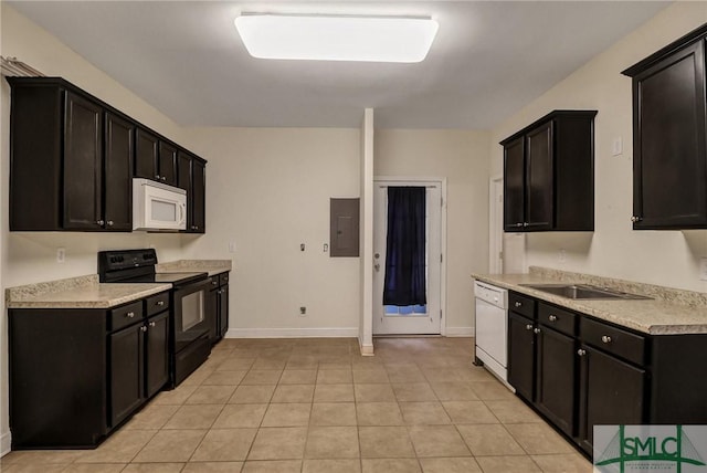 kitchen with light tile patterned floors, white appliances, a sink, light countertops, and electric panel