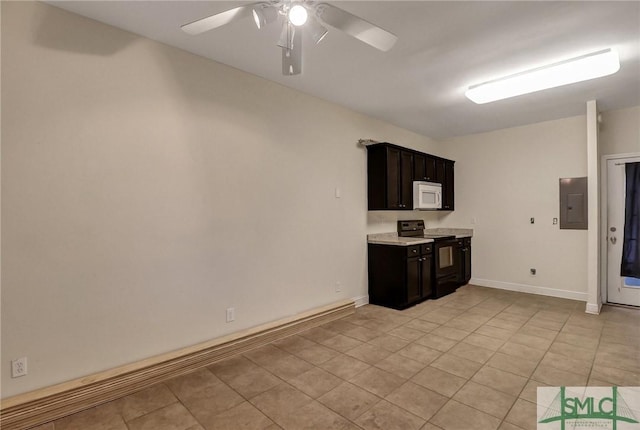 kitchen featuring light countertops, white microwave, a ceiling fan, light tile patterned flooring, and black range with electric cooktop